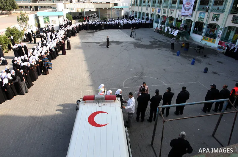 Palestinian schoolgirls take part in a civil defence exercises at a school in Rafah, in the southern of Gaza Strip on December 22, 2011. Photo by Abed Rahim Khatib