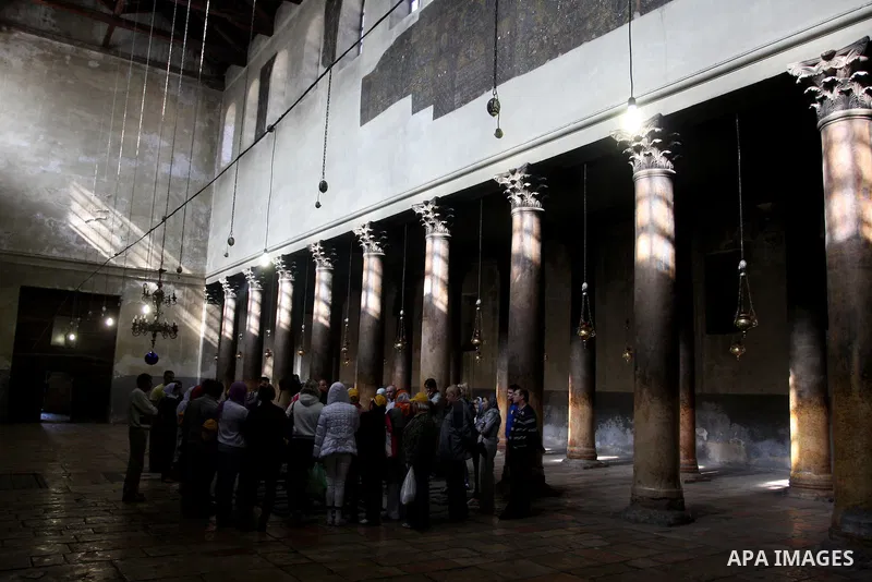 Christian pilgrims visit the Church of the Nativity in the biblical West Bank city of Bethlehem on 22 December 2011 as Christian pilgrims start gathering in the church belived to be the birthplace of Jesus Christ to cele...