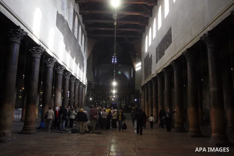 Christian pilgrims visit the Church of the Nativity in the biblical West Bank city of Bethlehem on 22 December 2011 as Christian pilgrims start gathering in the church belived to be the birthplace of Jesus Christ to cele...