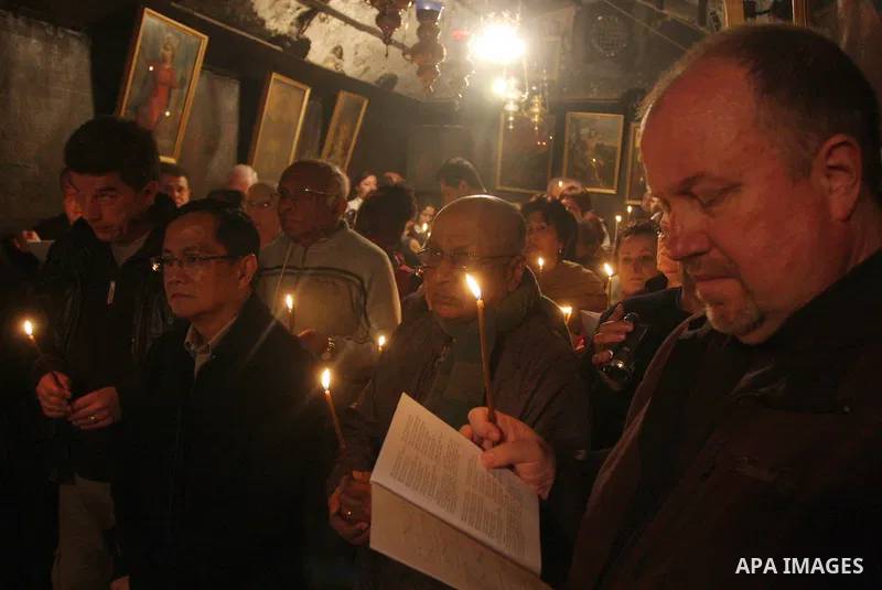 Christian pilgrims pray in the Church of the Nativity in the biblical West Bank city of Bethlehem on December 22, 2011, as Christian pilgrims started gathering in the traditional birthplace of Jesus Christ to attend the...
