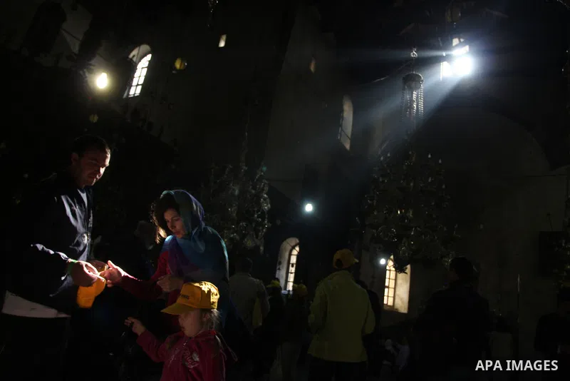 Christian pilgrims pray in the Church of the Nativity in the biblical West Bank city of Bethlehem on December 22, 2011, as Christian pilgrims started gathering in the traditional birthplace of Jesus Christ to attend the...