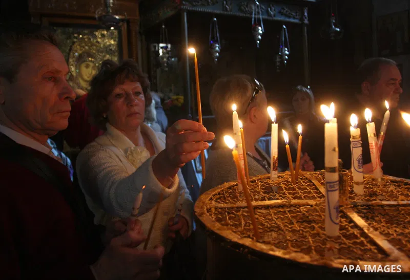 Christian pilgrims pray in the Church of the Nativity in the biblical West Bank city of Bethlehem on December 22, 2011, as Christian pilgrims started gathering in the traditional birthplace of Jesus Christ to attend the...