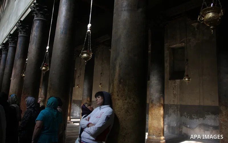Christian pilgrims pray in the Church of the Nativity in the biblical West Bank city of Bethlehem on December 22, 2011, as Christian pilgrims started gathering in the traditional birthplace of Jesus Christ to attend the...
