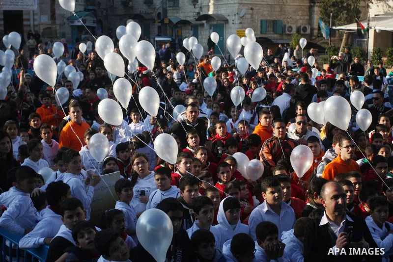 Children release balloons during an annual Christmas peace rally at Manger Square, outside the Church of the Nativity, the site revered as the birthplace of Jesus, in the West Bank town of Bethlehem December 22, 2011. Ph...