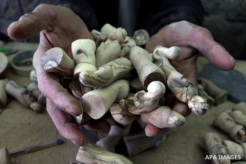 A Palestinian wood carver works on a nativity figurines are stored in an olive wood factory in the West Bank town of Bethlehem, ahead of Christmas,Thursday, Dec. 22, 2011. Photo by Issam Rimawi