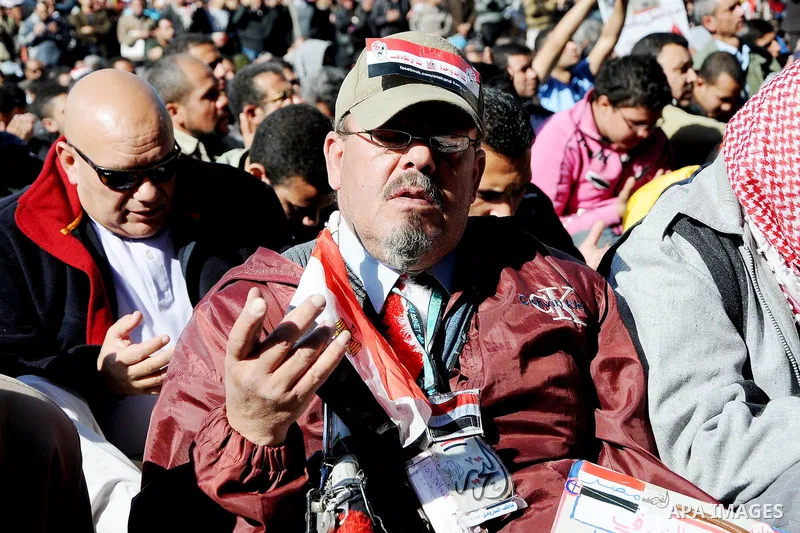 Protesters gather for Friday prayers next to a coffin bearing the national flag, symbolising Egyptians who died in the latest clashes at Tahrir Square, in Cairo December 23, 2011. Thousands of Egyptians rallied in Cairo...