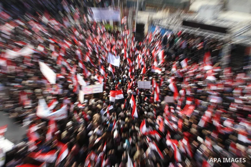 Supporters of the Egyptian military hold a giant Egyptian flag during a pro-military rally in Cairo's Abbassiya district on December 23, 2011. Thousands of anti-military protesters gathered in the nearby Tahrir Square to...