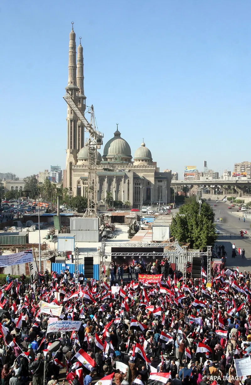 Supporters of the Egyptian military hold a giant Egyptian flag during a pro-military rally in Cairo's Abbassiya district on December 23, 2011. Thousands of anti-military protesters gathered in the nearby Tahrir Square to...