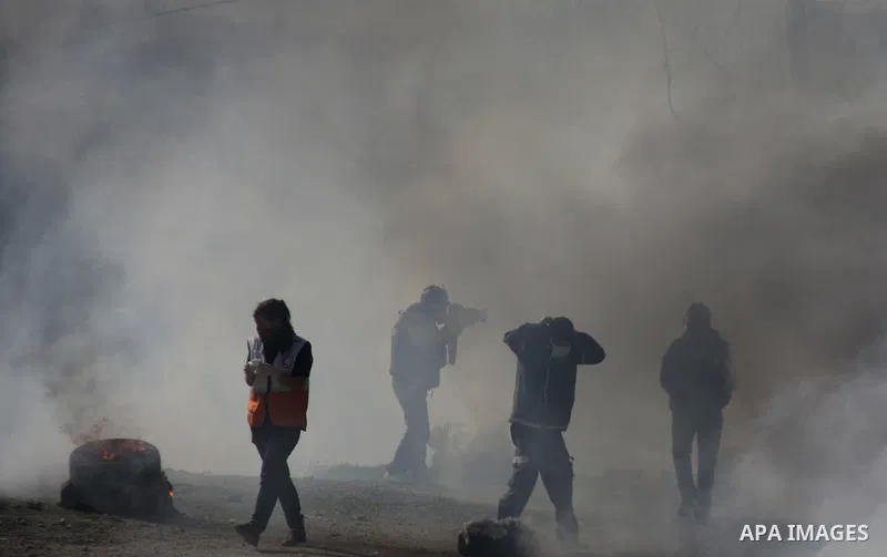 Palestinian protest hurl in tear gas at Israeli security forces ,during a protest in the village of Kufr Qaddum near the Israeli settlement of Kdumim, in the northern West Bank, Friday, Dec. 23, 2011 . Photo by Wagdi Esh...