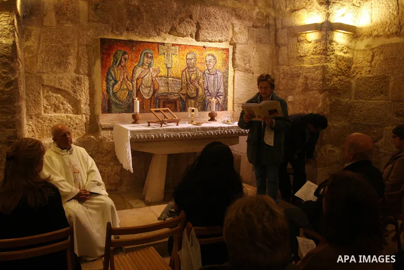 Christian pilgrims pray in the Church of the Nativity in the biblical West Bank city of Bethlehem on December 23, 2011, as Christian pilgrims started gathering in the traditional birthplace of Jesus Christ to attend the...