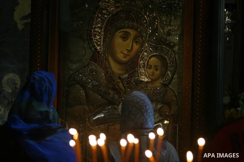Christian pilgrims pray in the Church of the Nativity in the biblical West Bank city of Bethlehem on December 23, 2011, as Christian pilgrims started gathering in the traditional birthplace of Jesus Christ to attend the...