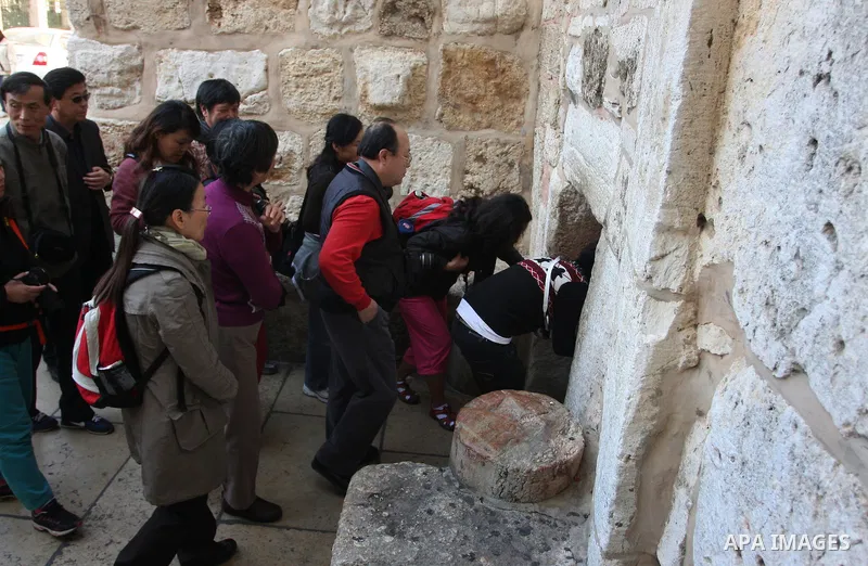 Christian pilgrims visit the Church of the Nativity in the biblical West Bank city of Bethlehem on 23 December 2011 as Christian pilgrims start gathering in the church belived to be the birthplace of Jesus Christ to cele...