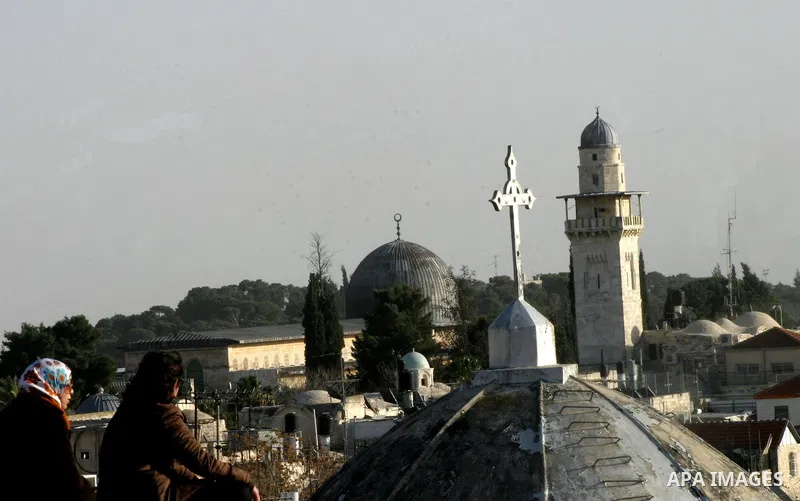 A Palestinian boy dressed-up in a Santa Claus costume,not seen' walks on Jerusalem's Old City walls on December 24, 2011. Photo by Mahfouz Abu Turk