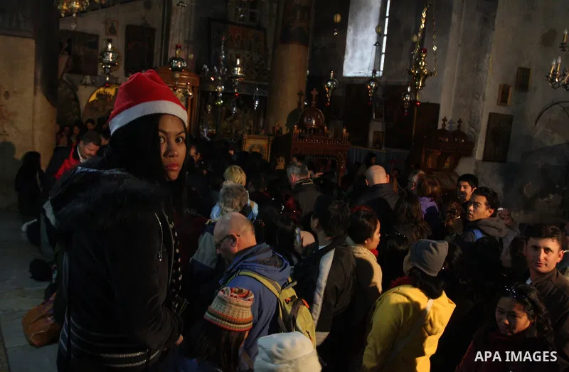 Christian pilgrims visit the Church of the Nativity in the biblical West Bank city of Bethlehem on Christmas Eve on 24 December 2011. Photo by Issam Rimawi