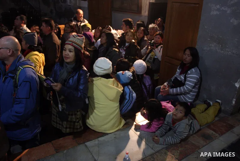 Christian pilgrims visit the Church of the Nativity in the biblical West Bank city of Bethlehem on Christmas Eve on 24 December 2011. Photo by Issam Rimawi