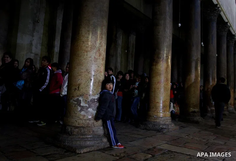 Christian pilgrims visit the Church of the Nativity in the biblical West Bank city of Bethlehem on Christmas Eve on 24 December 2011. Photo by Issam Rimawi