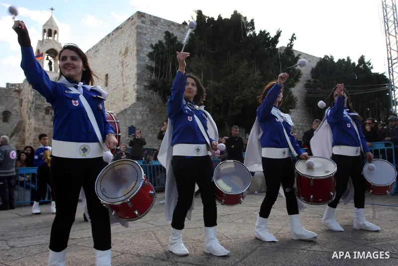 Palestinian Scouts play the bagpipes outside the Church of the Nativity while Christians gather for Christmas celebrations in the West Bank city of Bethlehem on December 24, 2011, as thousands of Christian pilgrims desce...