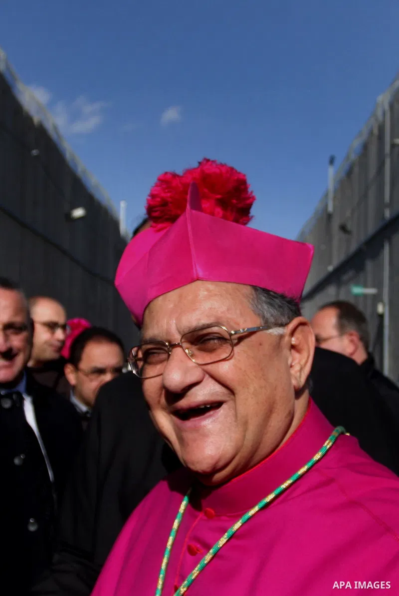 The head of the Roman Catholic Church in the Holy Land, the Latin Patriarch of Jerusalem Fuad Twal drives past the Israeli constructed separation barrier as he makes his way to the Church of the Nativity in the Biblical...