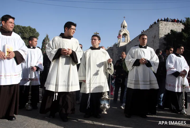 Christian pilgrims visit the Church of the Nativity in the biblical West Bank city of Bethlehem on Christmas Eve on 24 December 2011, as thousands of Christian pilgrims descended on the holy city to celebrate in Jesus' t...