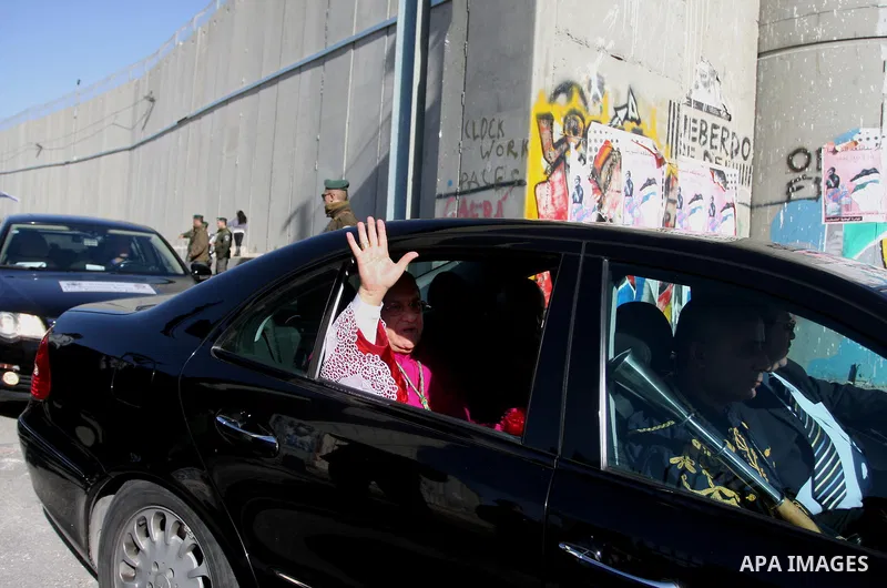 The head of the Roman Catholic Church in the Holy Land, the Latin Patriarch of Jerusalem Fuad Twal drives past the Israeli constructed separation barrier as he makes his way to the Church of the Nativity in the Biblical...