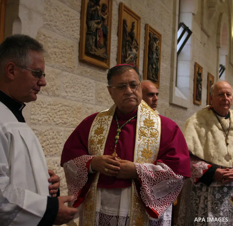 The Latin Patriarch of Jerusalem Fouad Twal waves upon his arrival to the Church of the Nativity to attend Christmas celebrations in West Bank town of Bethlehem December 24, 2011. Photo by Issam Rimawi