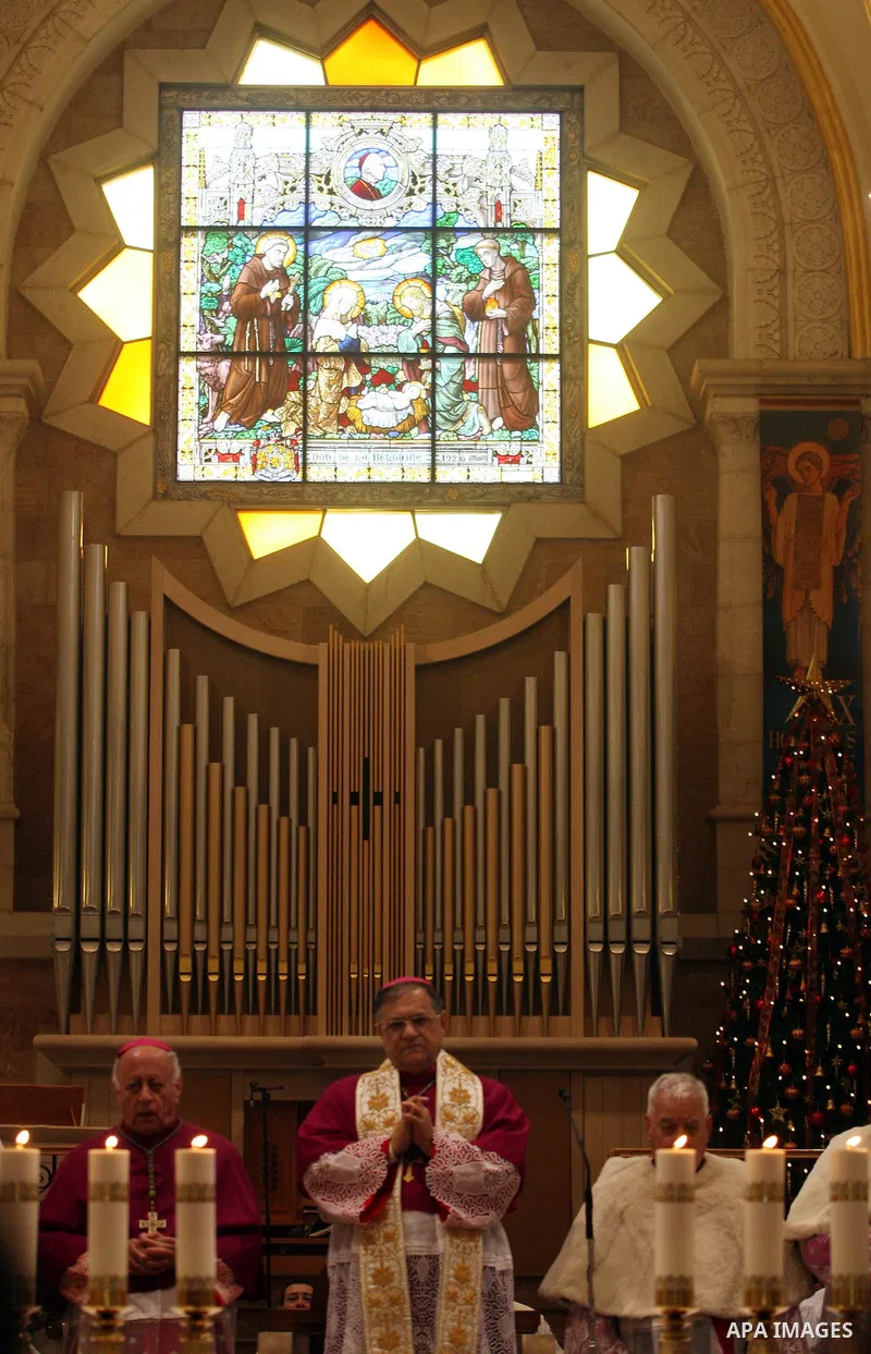 The Latin Patriarch of Jerusalem Fouad Twal waves upon his arrival to the Church of the Nativity to attend Christmas celebrations in West Bank town of Bethlehem December 24, 2011. Photo by Issam Rimawi