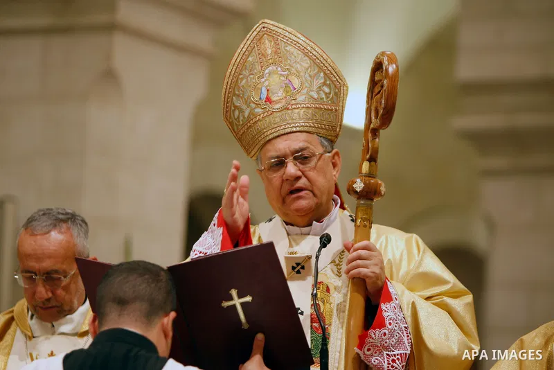 Latin Patriarch of Jerusalem Fouad Twal leads the Christmas midnight Mass at the Church of the Nativity, traditionally believed to be the birthplace of Jesus Christ, in the West Bank town of Bethlehem early Sunday, Dec....