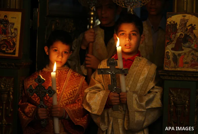Palestinian Christian boys hold candles during a service in the Saint Porfirios church in Gaza City on Christmas day December 25, 2011. Photo by Ashraf Amra