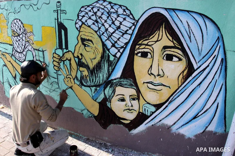 Palestinian Artists take part in paint a murals in the third anniversary of the Israeli war on Gaza Strip, in Gaza city on Dec. 27,2011. Photo by Mohammed Asad