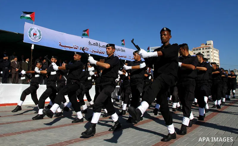 Palestinian members of Hamas security forces stand in formation during a graduation ceremony for new recruits in Gaza City on December 27, 2011. Photo by Ashraf Amra.