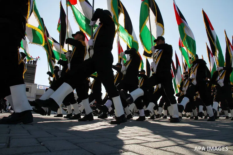 Palestinian Hamas security men march during a graduation ceremony of a military training course of the ministry of interior in Gaza City on 27 December 2011. Photo by Ashraf Amra.