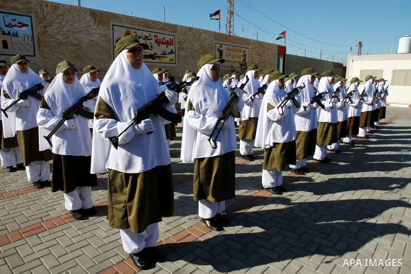 Palestinian Hamas security women march during a graduation ceremony of a military training course of the ministry of interior in Gaza City on 27 December 2011. Photo by Ashraf Amra.