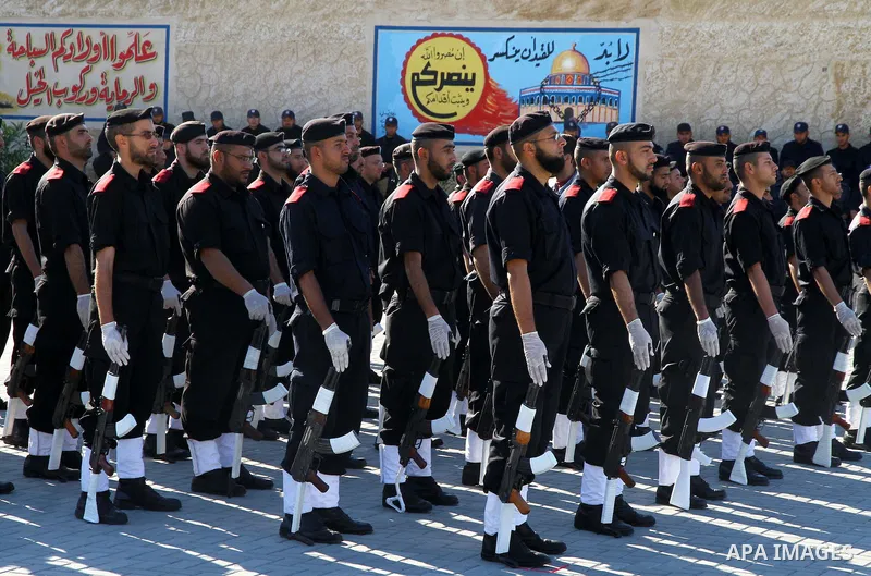 Palestinian members of Hamas security forces stand in formation during a graduation ceremony for new recruits in Gaza City on December 27, 2011. Photo by Ashraf Amra.