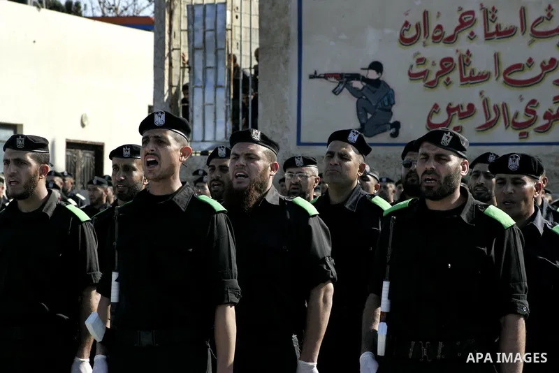 Palestinian members of Hamas security forces stand in formation during a graduation ceremony for new recruits in Gaza City on December 27, 2011. Photo by Ashraf Amra.