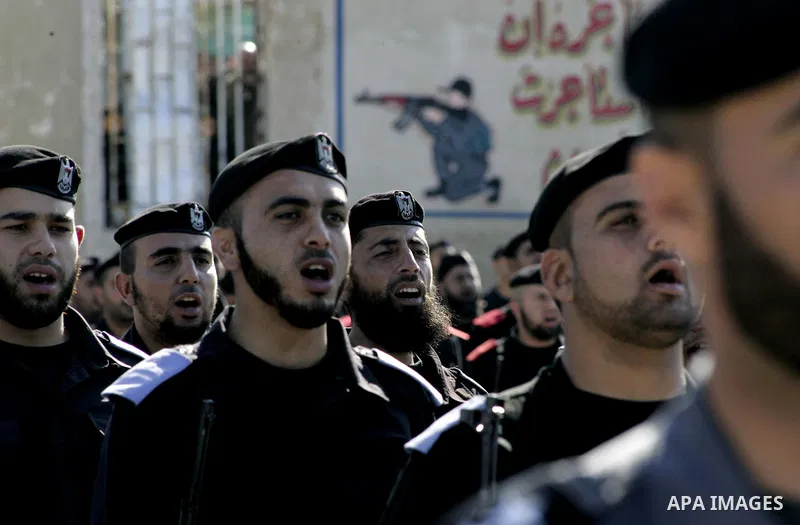 Palestinian members of Hamas security forces stand in formation during a graduation ceremony for new recruits in Gaza City on December 27, 2011. Photo by Ashraf Amra.