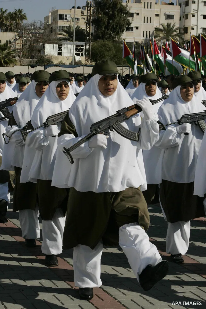 Palestinian Hamas security women march during a graduation ceremony of a military training course of the ministry of interior in Gaza City on 27 December 2011. Photo by Ashraf Amra.
