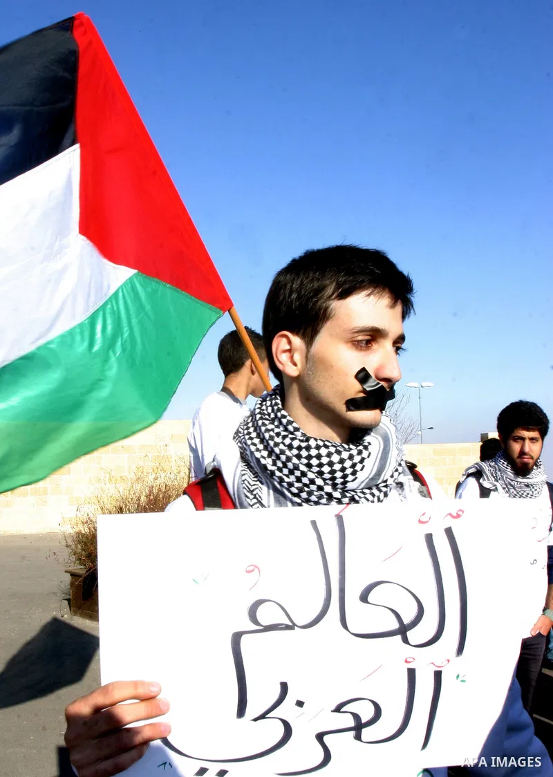 Demonstrators take part in a protest against israeli army in a anniversary of the Israeli war on the Gaza Strip in 2008, in East Jerusalem on Dec. 27, 2011. Photo by Mahfouz Abu Turk