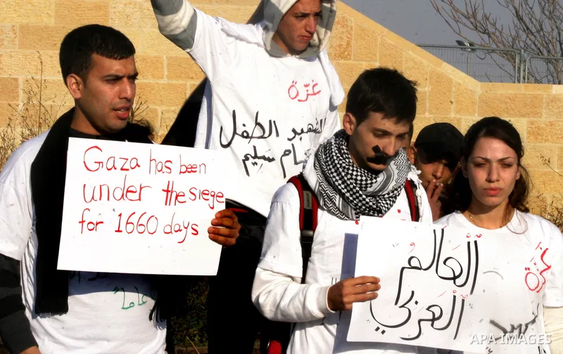 Demonstrators take part in a protest against israeli army in a anniversary of the Israeli war on the Gaza Strip in 2008, in East Jerusalem on Dec. 27, 2011. Photo by Mahfouz Abu Turk