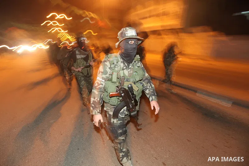 Masked Hamas militants march with their guns during a parade to mark the third anniversary of the Israeli offensive on Gaza in 2008, in Gaza City, Tuesday, Dec. 27, 2011. Palestinians mark the third anniversary of the th...