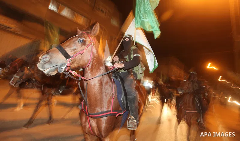 Masked Hamas militants march with their guns during a parade to mark the third anniversary of the Israeli offensive on Gaza in 2008, in Gaza City, Tuesday, Dec. 27, 2011. Palestinians mark the third anniversary of the th...