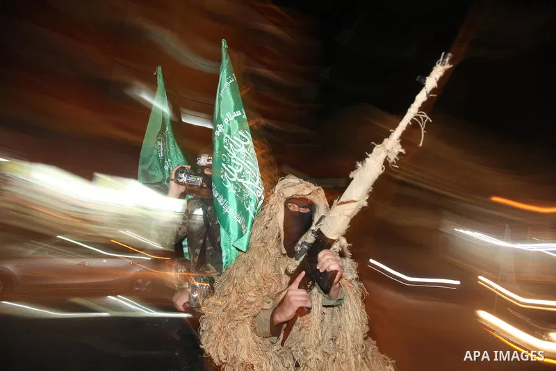 Masked Hamas militants march with their guns during a parade to mark the third anniversary of the Israeli offensive on Gaza in 2008, in Gaza City, Tuesday, Dec. 27, 2011. Palestinians mark the third anniversary of the th...