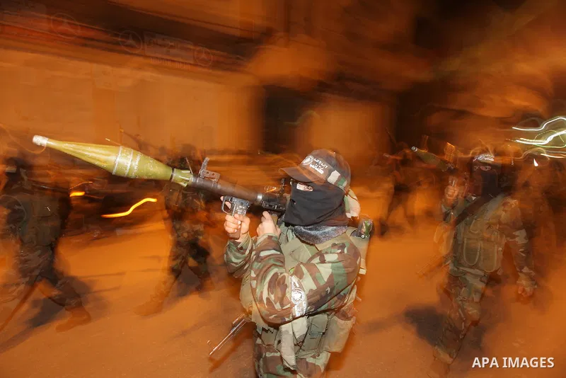 Masked Hamas militants march with their guns during a parade to mark the third anniversary of the Israeli offensive on Gaza in 2008, in Gaza City, Tuesday, Dec. 27, 2011. Palestinians mark the third anniversary of the th...