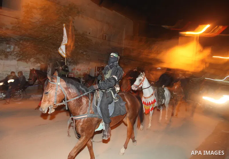 Masked Hamas militants march with their guns during a parade to mark the third anniversary of the Israeli offensive on Gaza in 2008, in Gaza City, Tuesday, Dec. 27, 2011. Palestinians mark the third anniversary of the th...