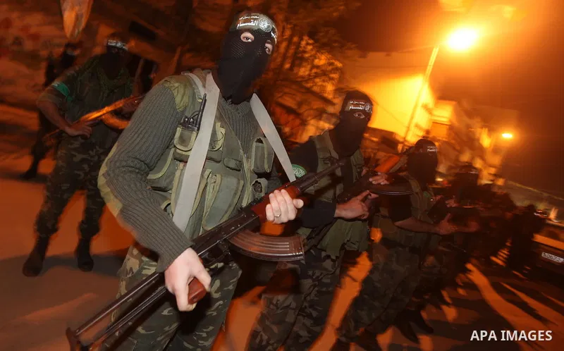 Masked Hamas militants march with their guns during a parade to mark the third anniversary of the Israeli offensive on Gaza in 2008, in Gaza City, Tuesday, Dec. 27, 2011. Palestinians mark the third anniversary of the th...