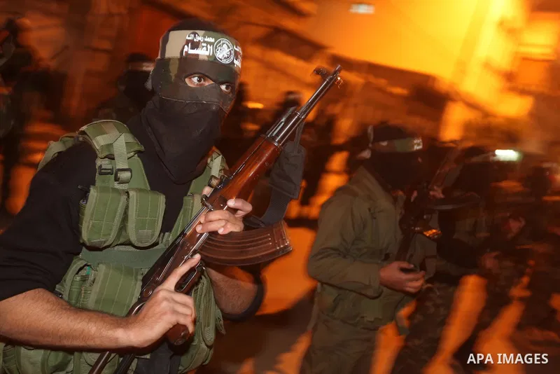 Masked Hamas militants march with their guns during a parade to mark the third anniversary of the Israeli offensive on Gaza in 2008, in Gaza City, Tuesday, Dec. 27, 2011. Palestinians mark the third anniversary of the th...