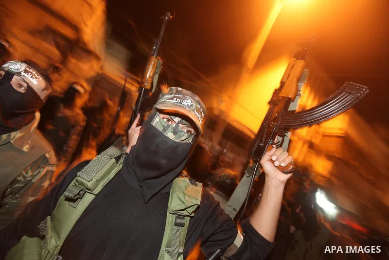 Masked Hamas militants march with their guns during a parade to mark the third anniversary of the Israeli offensive on Gaza in 2008, in Gaza City, Tuesday, Dec. 27, 2011. Palestinians mark the third anniversary of the th...