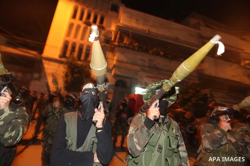 Masked Hamas militants march with their guns during a parade to mark the third anniversary of the Israeli offensive on Gaza in 2008, in Gaza City, Tuesday, Dec. 27, 2011. Palestinians mark the third anniversary of the th...