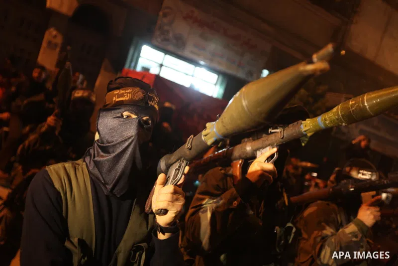 Masked Hamas militants march with their guns during a parade to mark the third anniversary of the Israeli offensive on Gaza in 2008, in Gaza City, Tuesday, Dec. 27, 2011. Palestinians mark the third anniversary of the th...