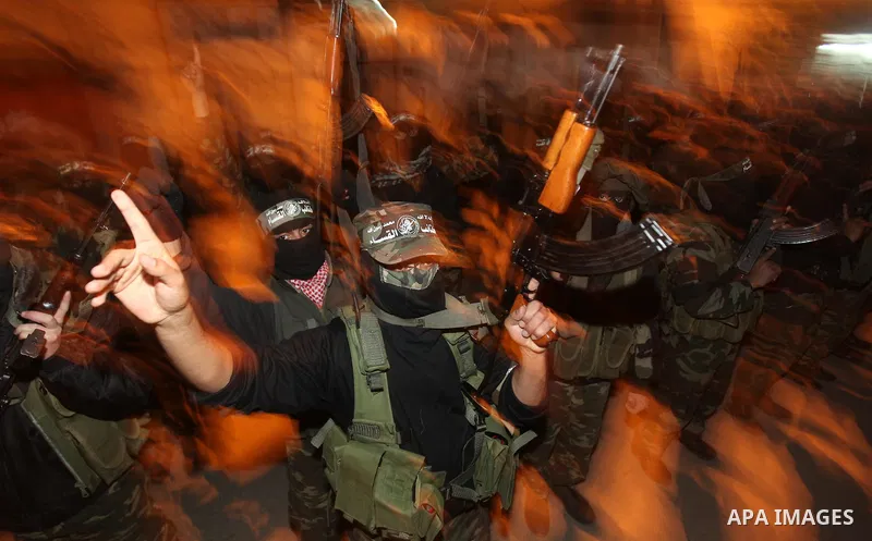 Masked Hamas militants march with their guns during a parade to mark the third anniversary of the Israeli offensive on Gaza in 2008, in Gaza City, Tuesday, Dec. 27, 2011. Palestinians mark the third anniversary of the th...