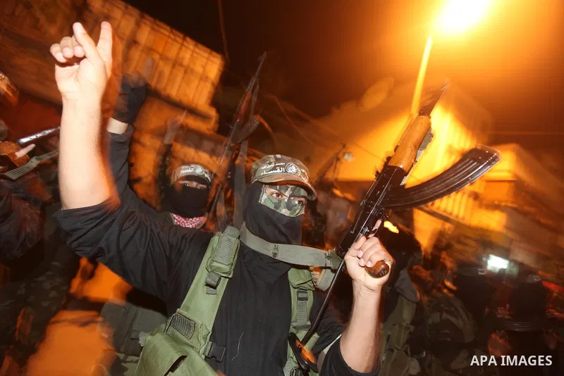 Masked Hamas militants march with their guns during a parade to mark the third anniversary of the Israeli offensive on Gaza in 2008, in Gaza City, Tuesday, Dec. 27, 2011. Palestinians mark the third anniversary of the th...